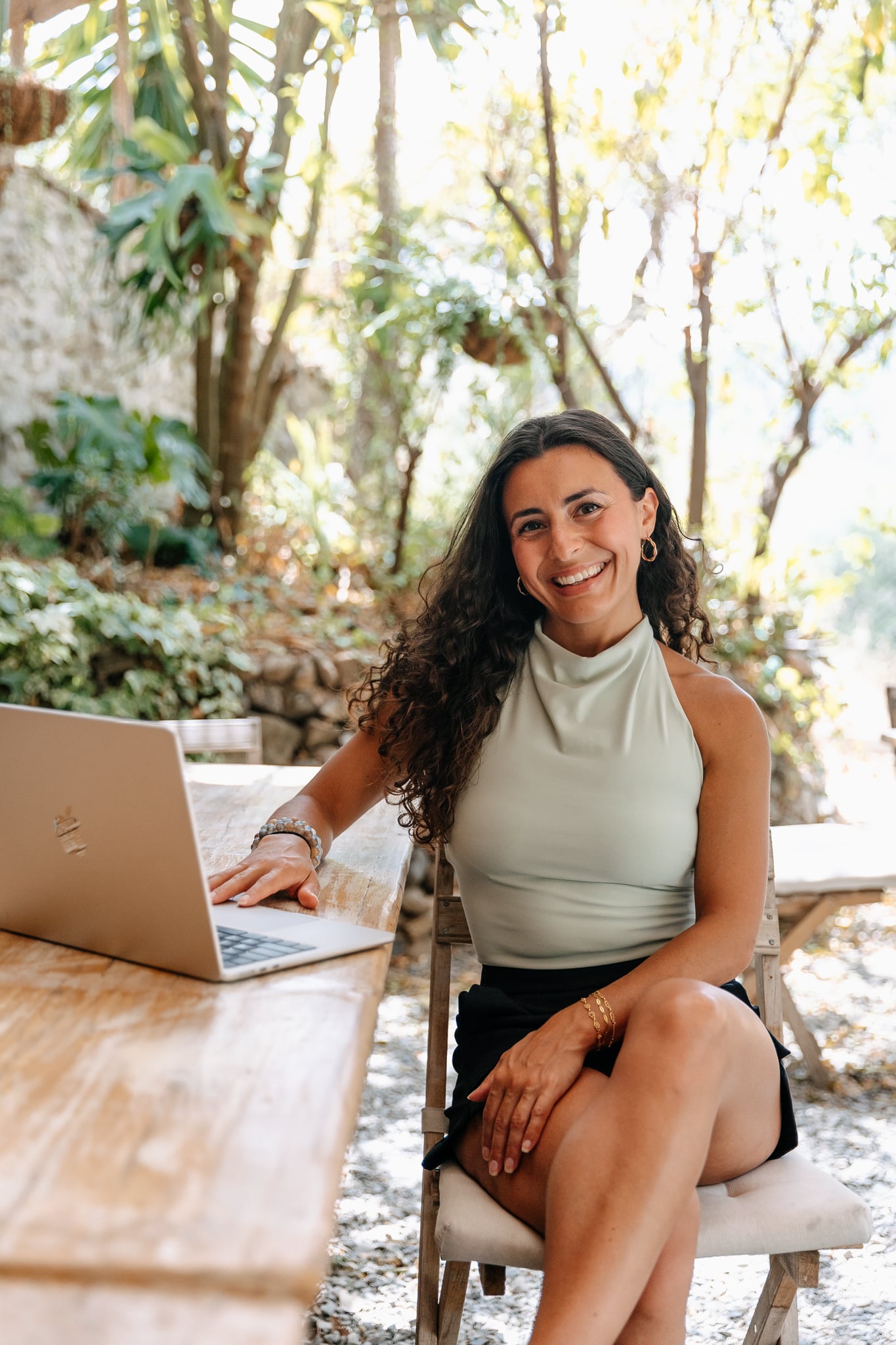 Image of waterfall pouring into pond surrounded by lush foliage.